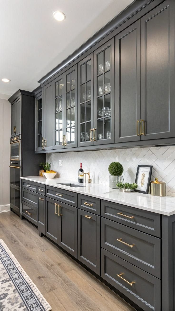 Charcoal kitchen cabinets refinished with brass hardware in a Round Rock home